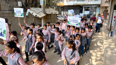 School children march with Swachhata placards during the Sulabh cleanliness rally on Palam-Dabri Road, New Delhi