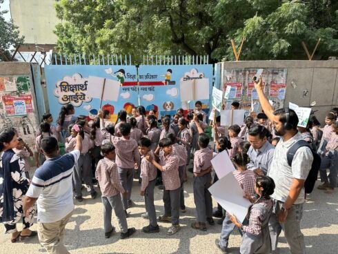 Students assemble with placards outside the school gate before the Swachhata Hi Seva 2026 cleanliness rally in Mahavir Enclave