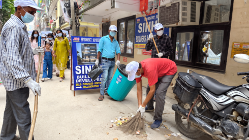 Sulabh volunteers sweep and collect litter during the Swachhata Hi Seva 2026 cleanliness drive at Mahavir Enclave, New Delhi